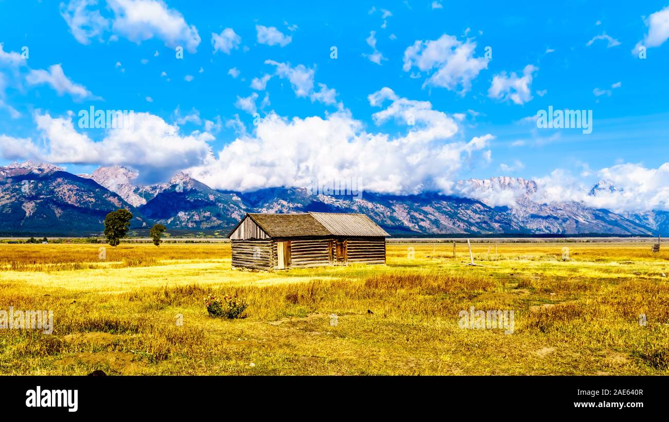 An abandoned Barn at Mormon Row with in the background cloud covered Peaks of the Grand Tetons In Grand Tetons National Park near Jackson Hole, WY USA Stock Photo