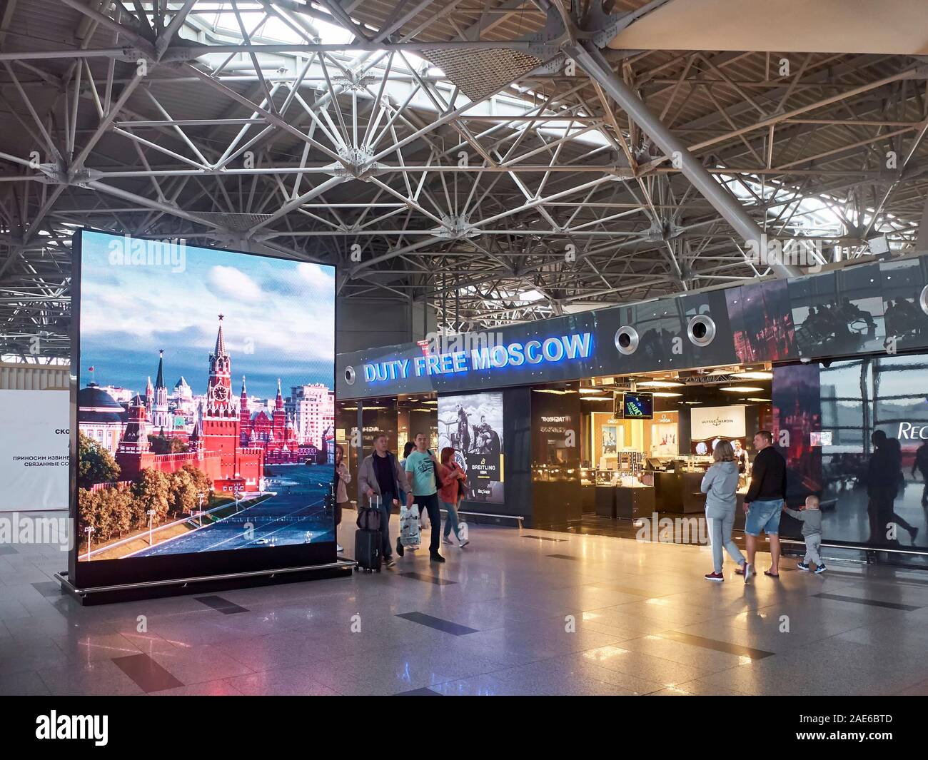 People are passing by duty free shops in the airport departure zone. Vnukovo airport, Russia - May 2019. Stock Photo