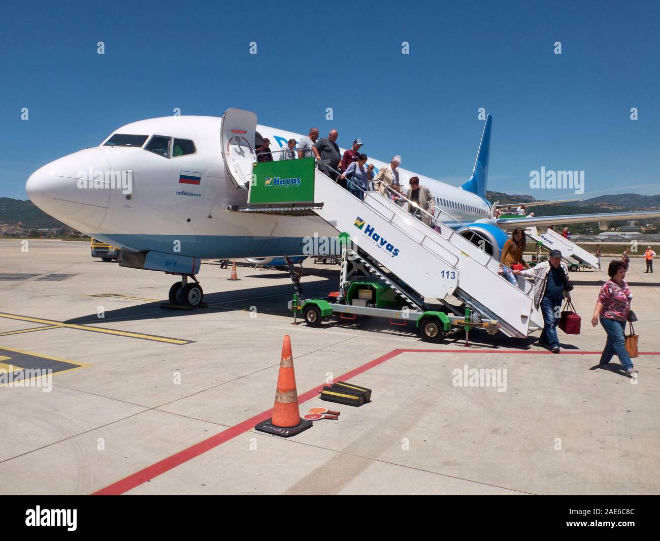 Passengers of Pobeda Airlines comes off the plane to airfield. Gazipasha airport, Turkey - May 2019. Stock Photo