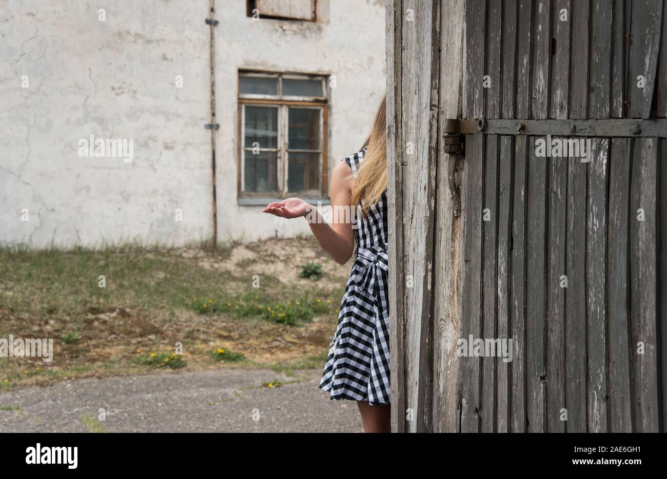 Young woman with outstretched hand on the background of old buildings. Stock Photo