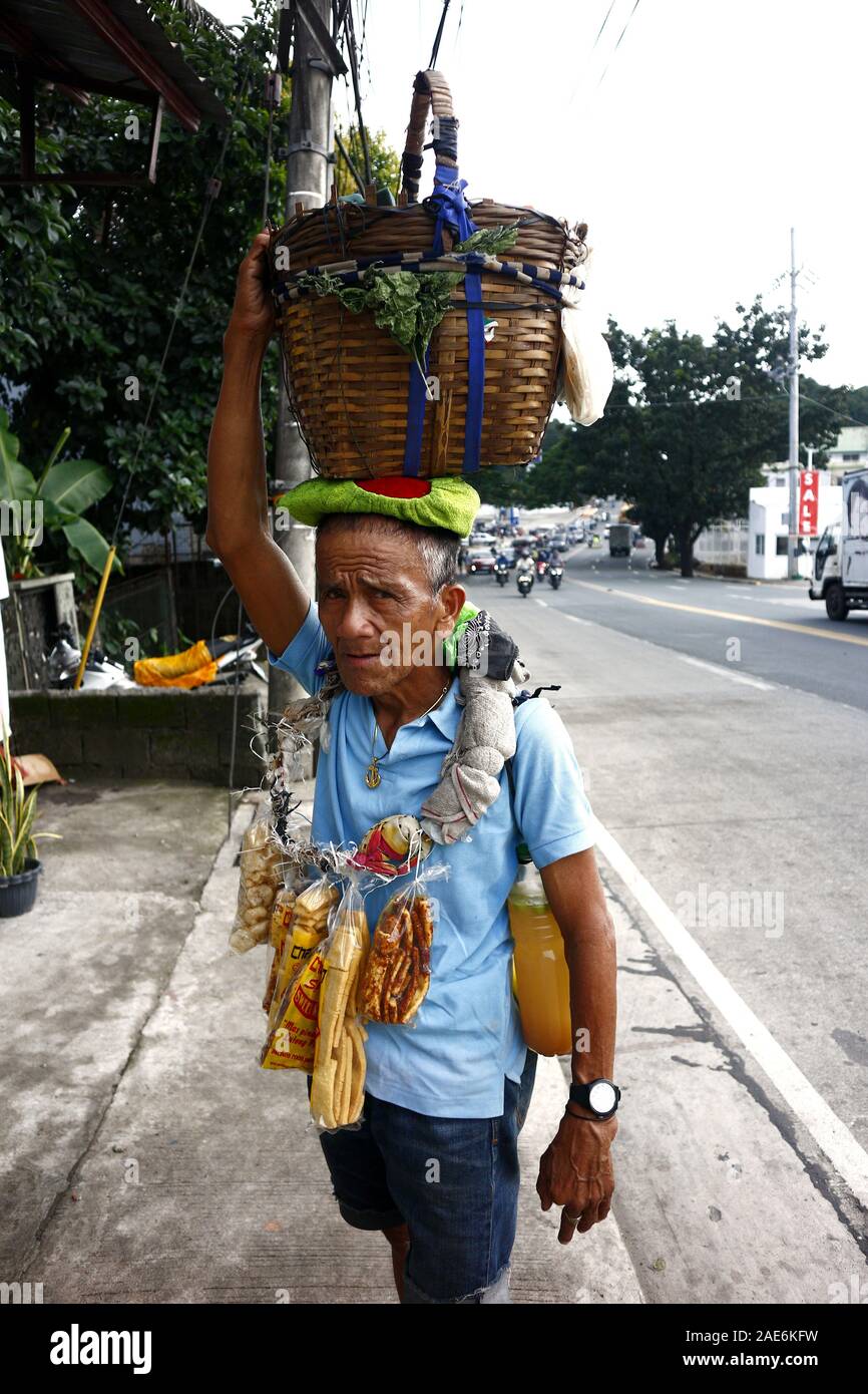 Antipolo City, Philippines – December 5, 2019: Street vendor sells Balut or steamed duck egg and Chicharon or fried pork skin. Stock Photo