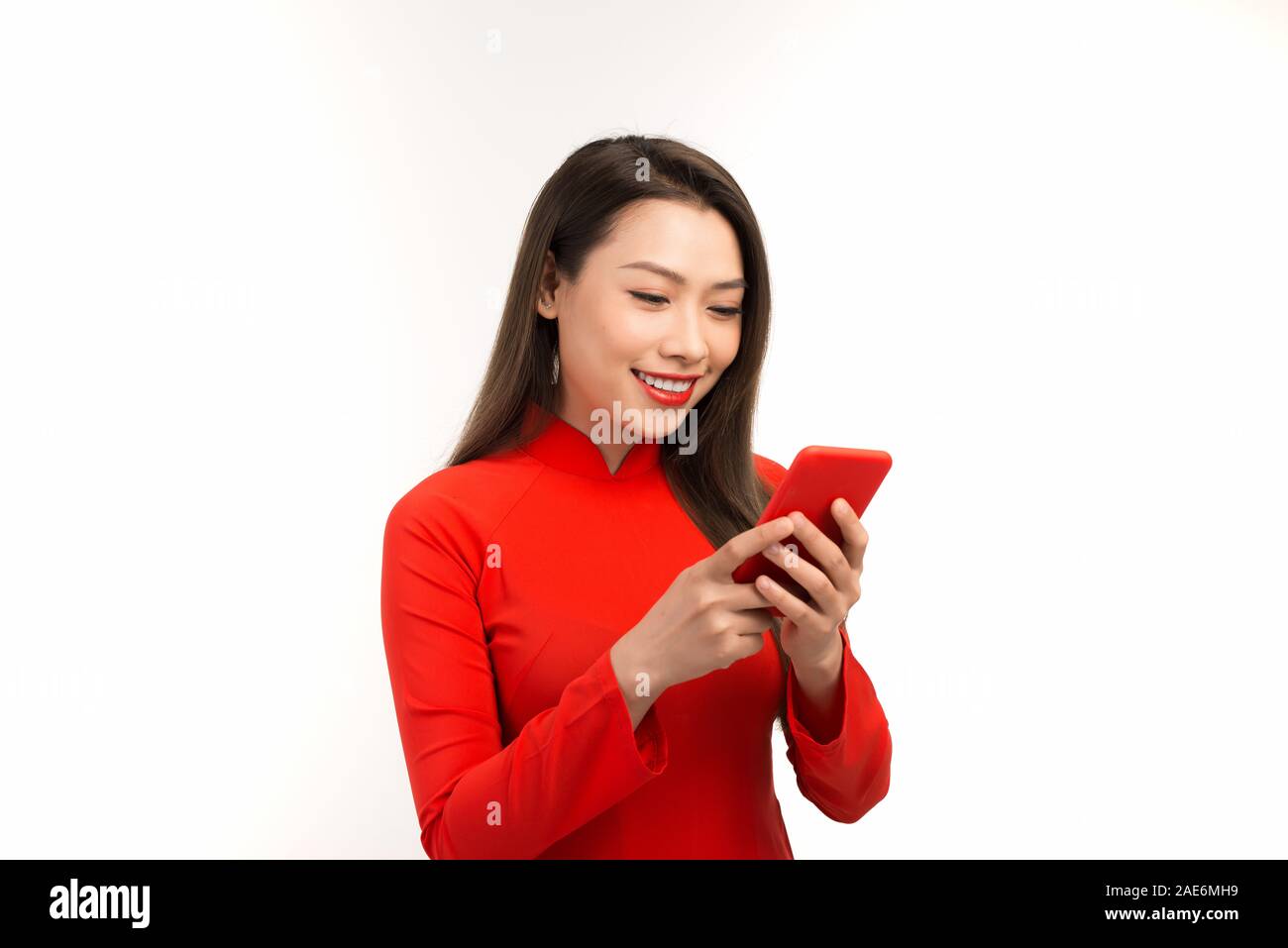 Asian Woman Shocked Product Sale of Vietnamese New Year Day Shopping Online on Mobile or Smartphone. Stock Photo