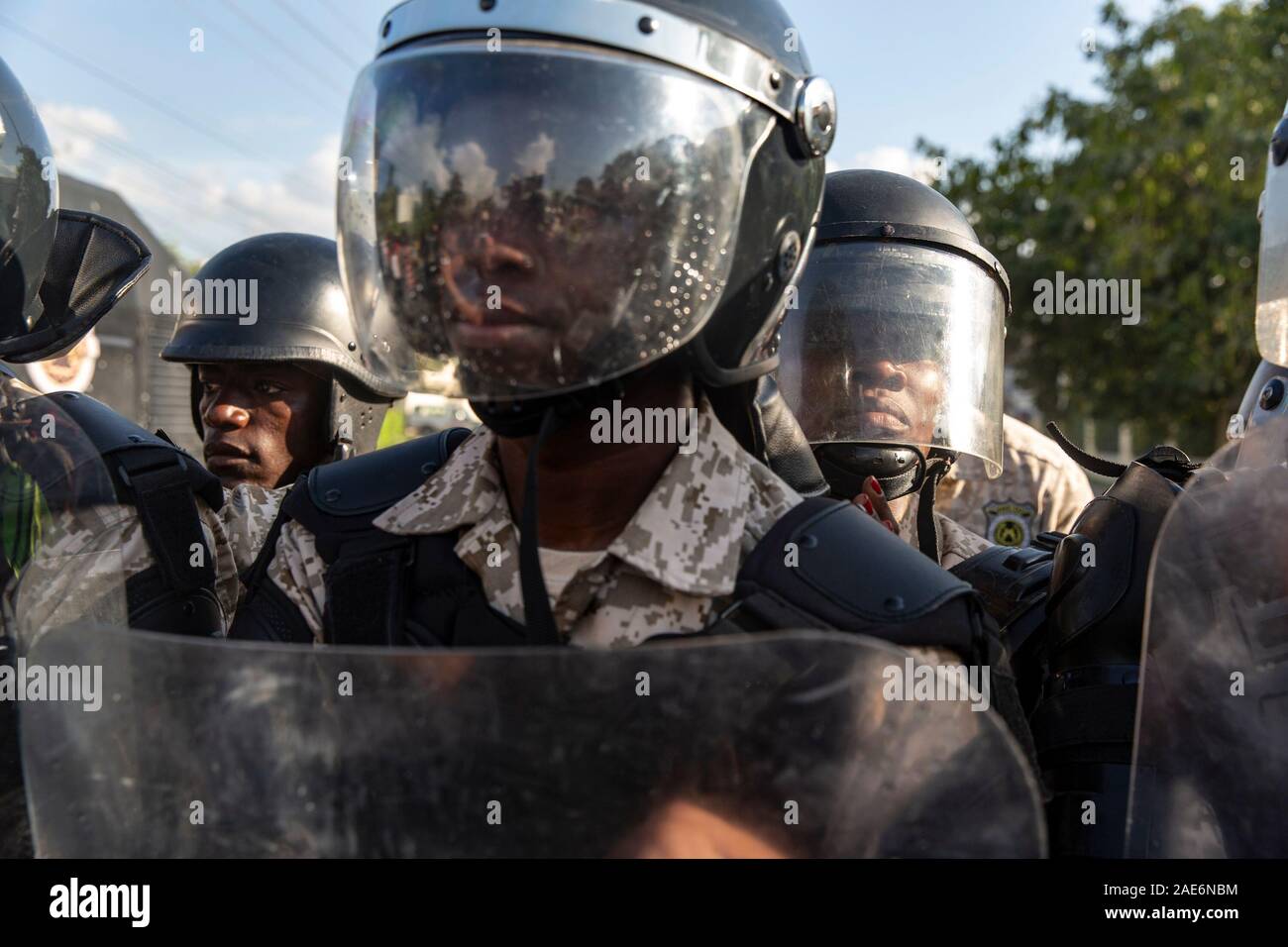 Port Au Prince, Haiti. 06th Dec, 2019. A phalanx of Haitian police form a barricade to keep protesters from getting any closer to the US Embassy during the demonstration.For over a year tensions has been high in Haiti, widespread governmental corruption and the misuse of Venezuelan loans through the Petro Caribe program has led many people to take to the streets demanding that President Jovenel Moïse steps down. Country wide protests and the threat of violence has brought the nation to a near standstill with many businesses and schools have now been shuttered for months. Credit: SOPA Images Li Stock Photo