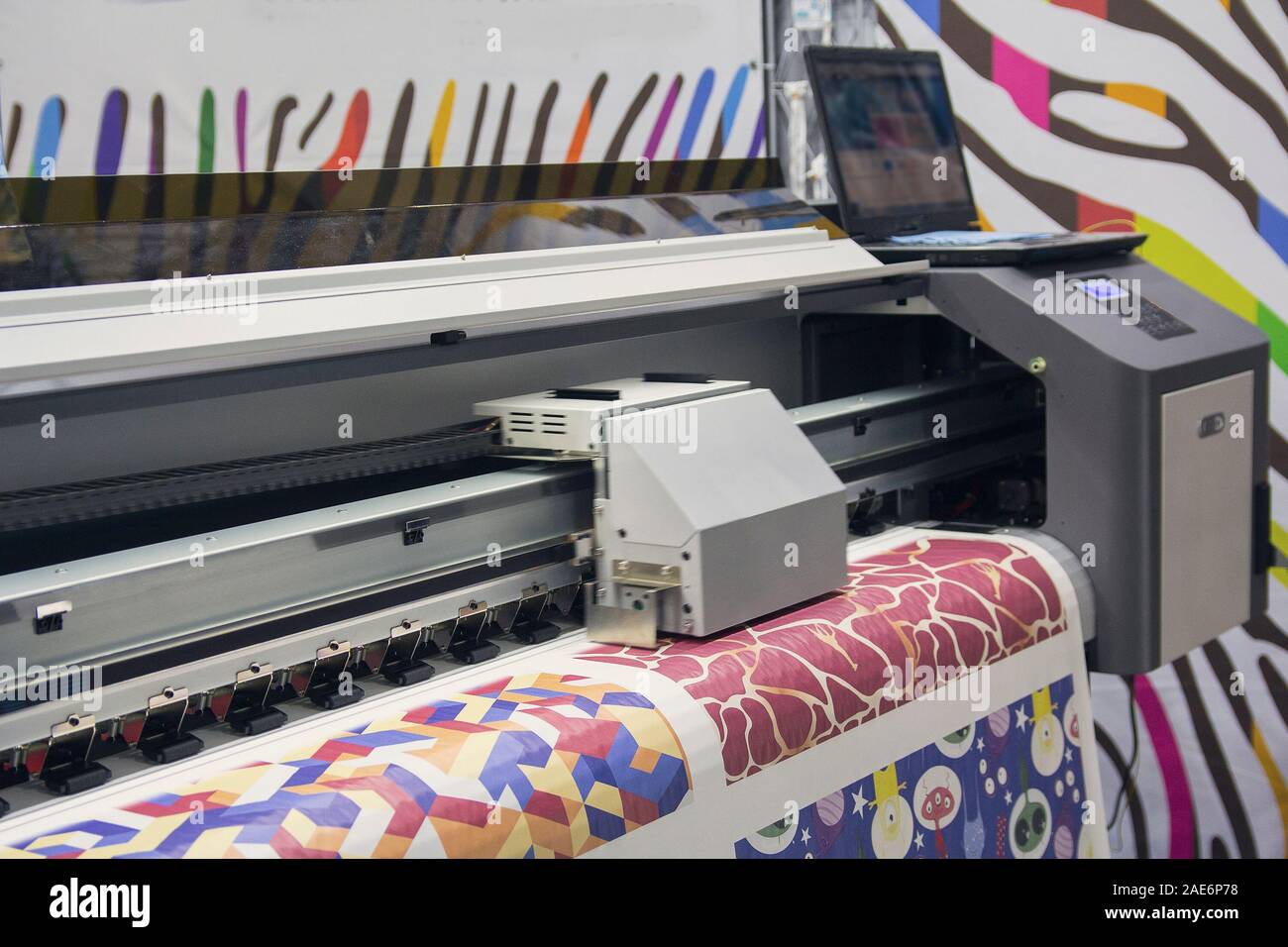Large format printing machine in operation. Industry Stock Photo
