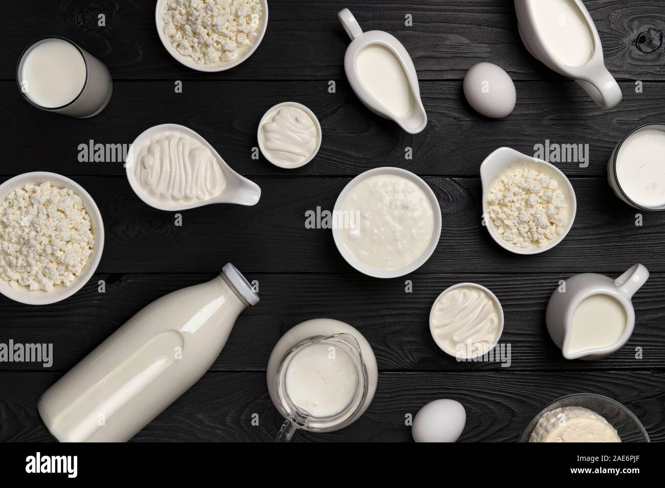 Different Types Of Dairy Products On Black Wooden Background Set