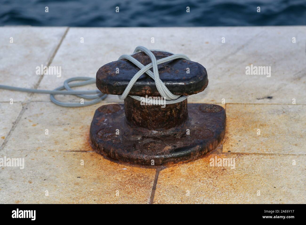 Bollard with a mooring line wrapped around it Stock Photo Alamy