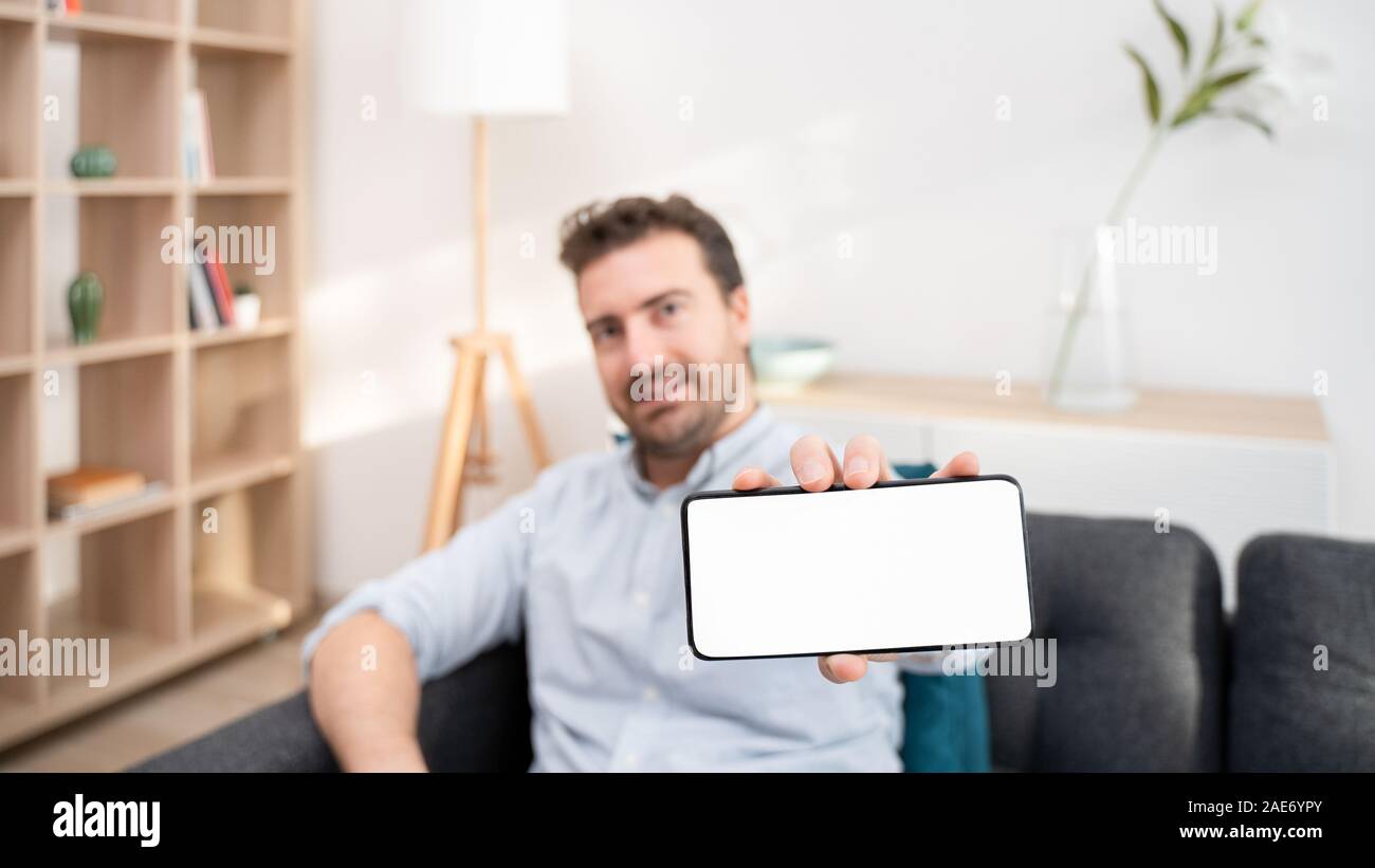 Man Showing Mobile Phone Display And Blank Screen Copy Space For