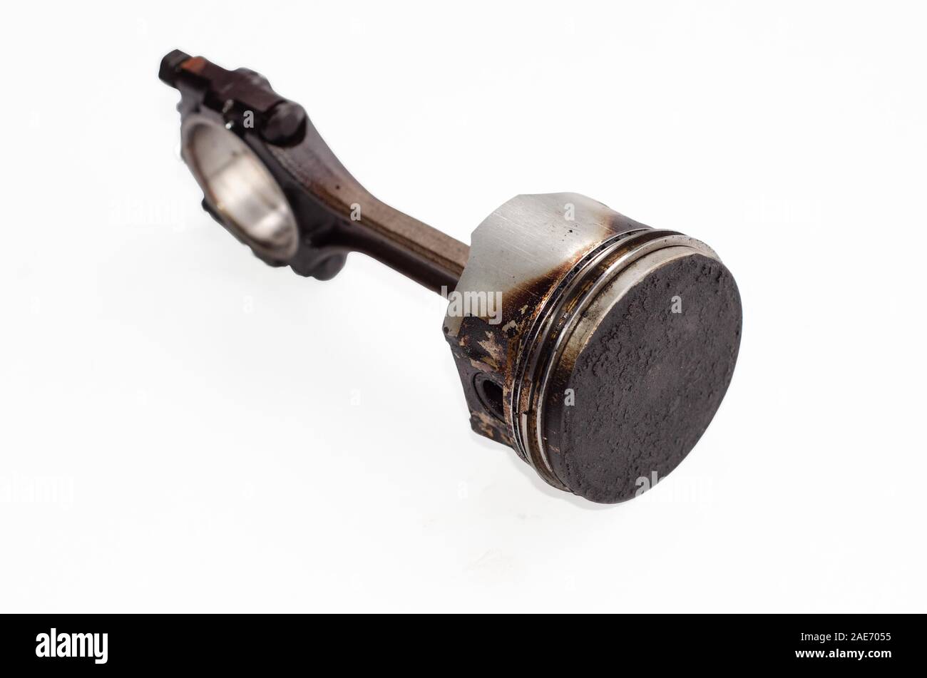 Piston with carbon deposits and connecting rod isolated on white Stock