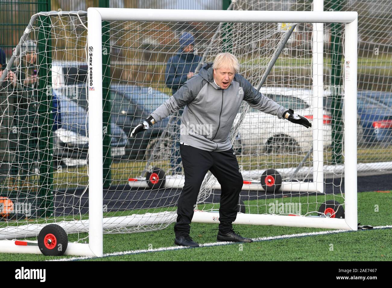 Prime Minister Boris Johnson tries his hand in goal before a football match between Hazel Grove Utd and Poynton Jnr u10s in the Cheshire Girls football league in Cheadle Hume, Cheshire, while on the election campaign trail. Stock Photo