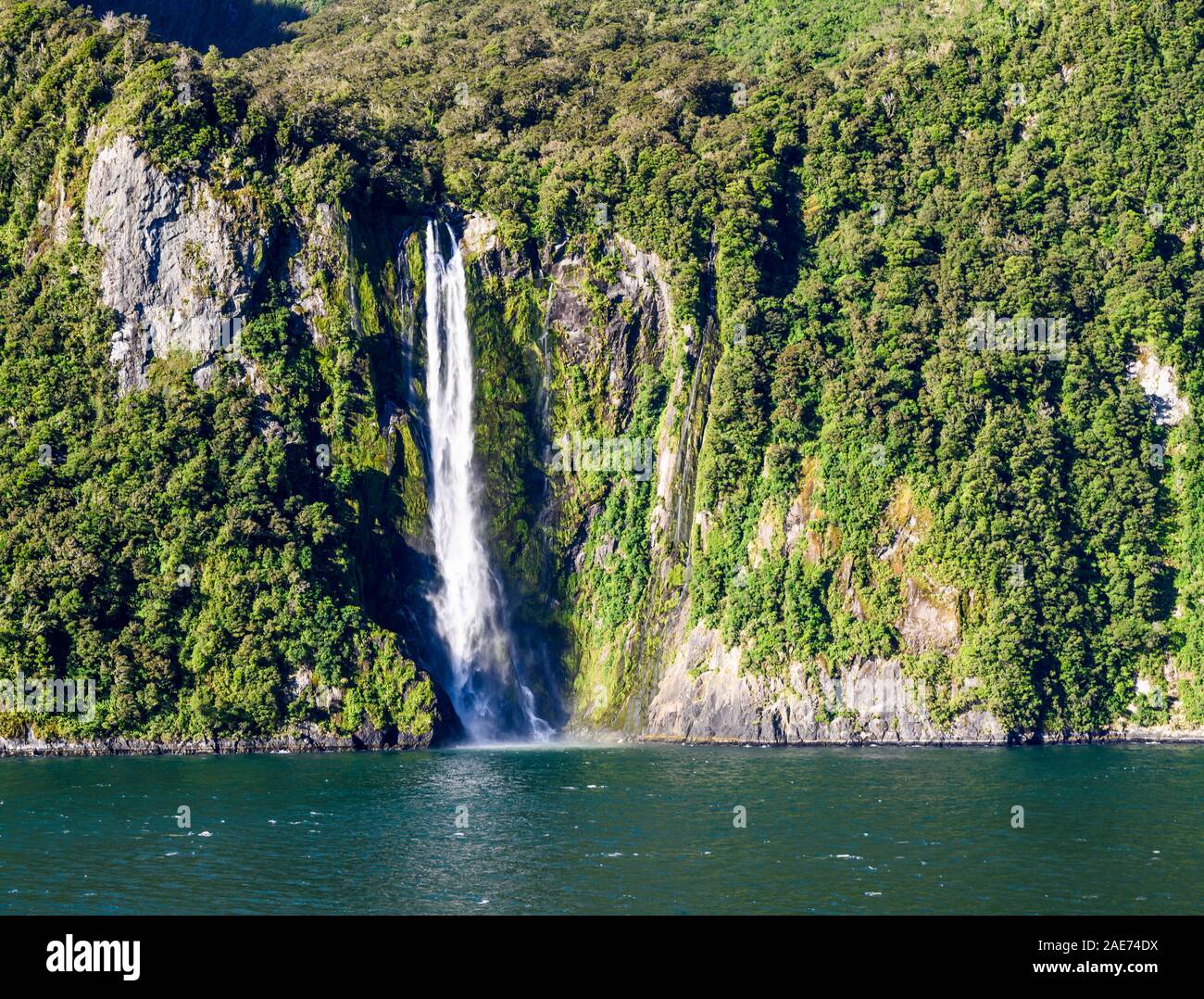 Stirling Falls, amid spectacular fiord scenery in Milford Sound, Fiordland National Park, New Zealand. Stock Photo