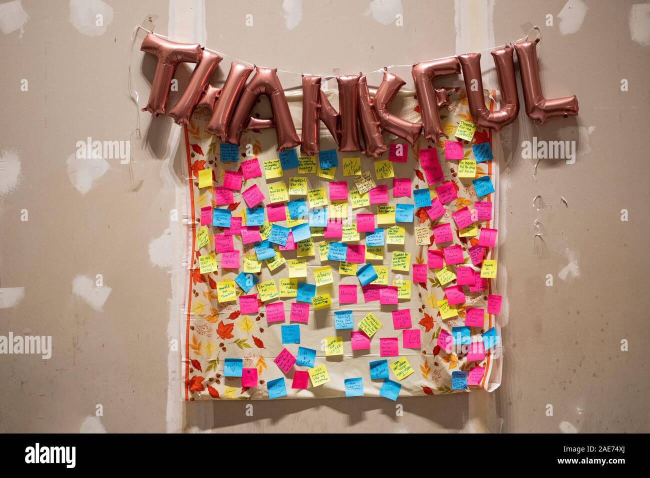 Around the Thanksgiving holiday, a Starbucks on Park Ave & . 34th St. had post-it notes from customers about what they are thankful for & wishing for. Stock Photo