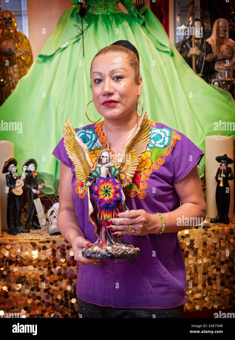Posed photo of a leader of a Santa Muerte congregation at her home temple in Jackson Heights, Queens, New York City. Stock Photo