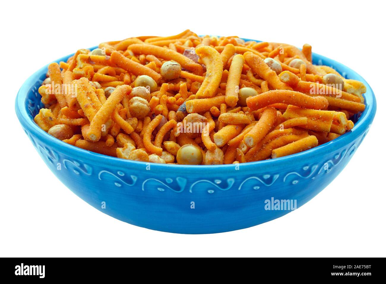 Spicy chilli Bombay mix in an ornate blue bowl on an isolated white background with a clipping path Stock Photo