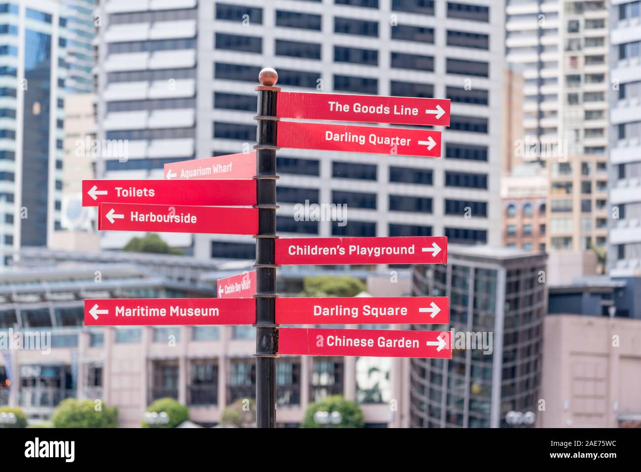 A helpful sign post in Sydney's Darling Harbour area pointing to Darling Square and Quarter, The Maritime Museum and other nearby destinations Stock Photo
