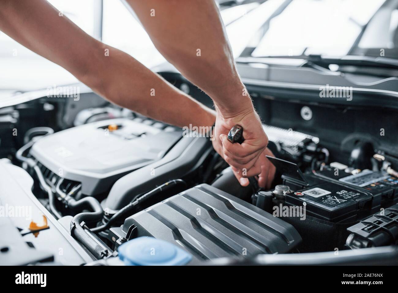 Give me just a moment to fix that. Process of repairing car after accident. Man working with