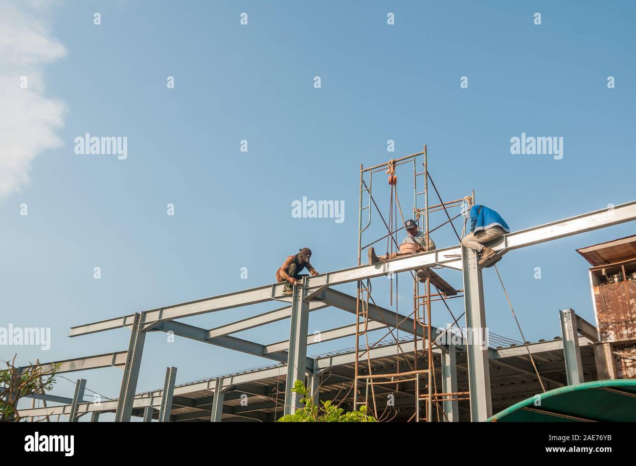 workers on top a metallic structure, construction site, Bali Stock Photo