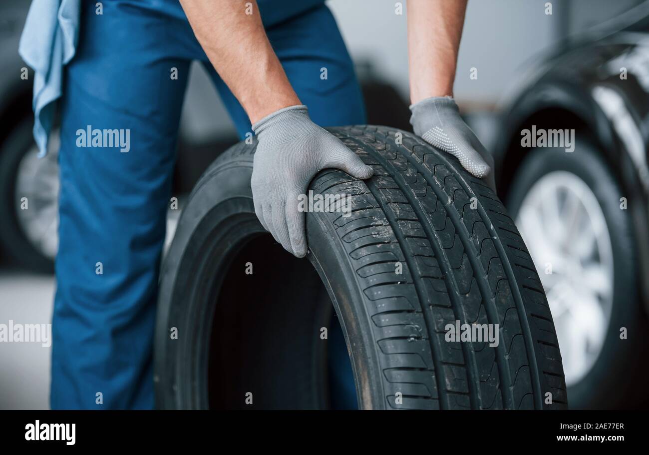 One more improvement and job will be done. Mechanic holding a tire at