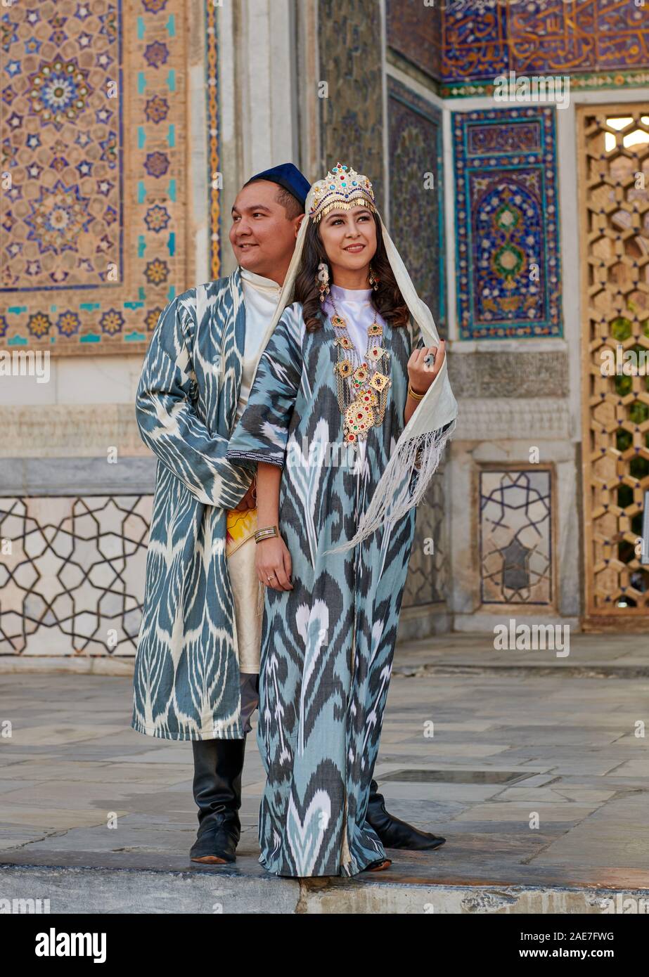 bridal couple in traditional clothes posing in front of famous ...