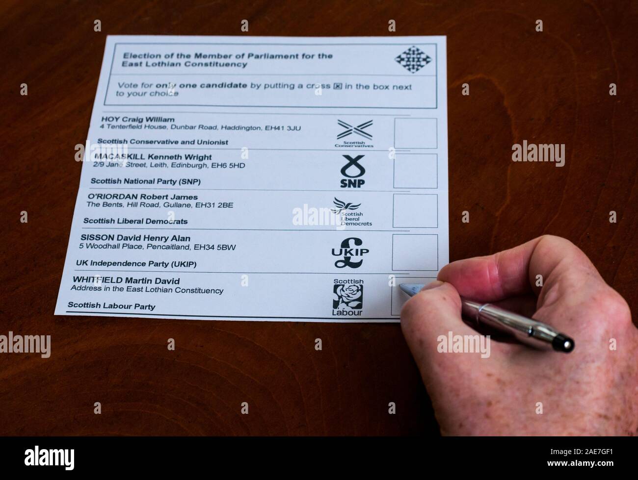 Man voting for Scottish Labour candidate Martin Whitfield on postal ballot paper in general election 2019 in East Lothian constituency, Scotland, UK Stock Photo