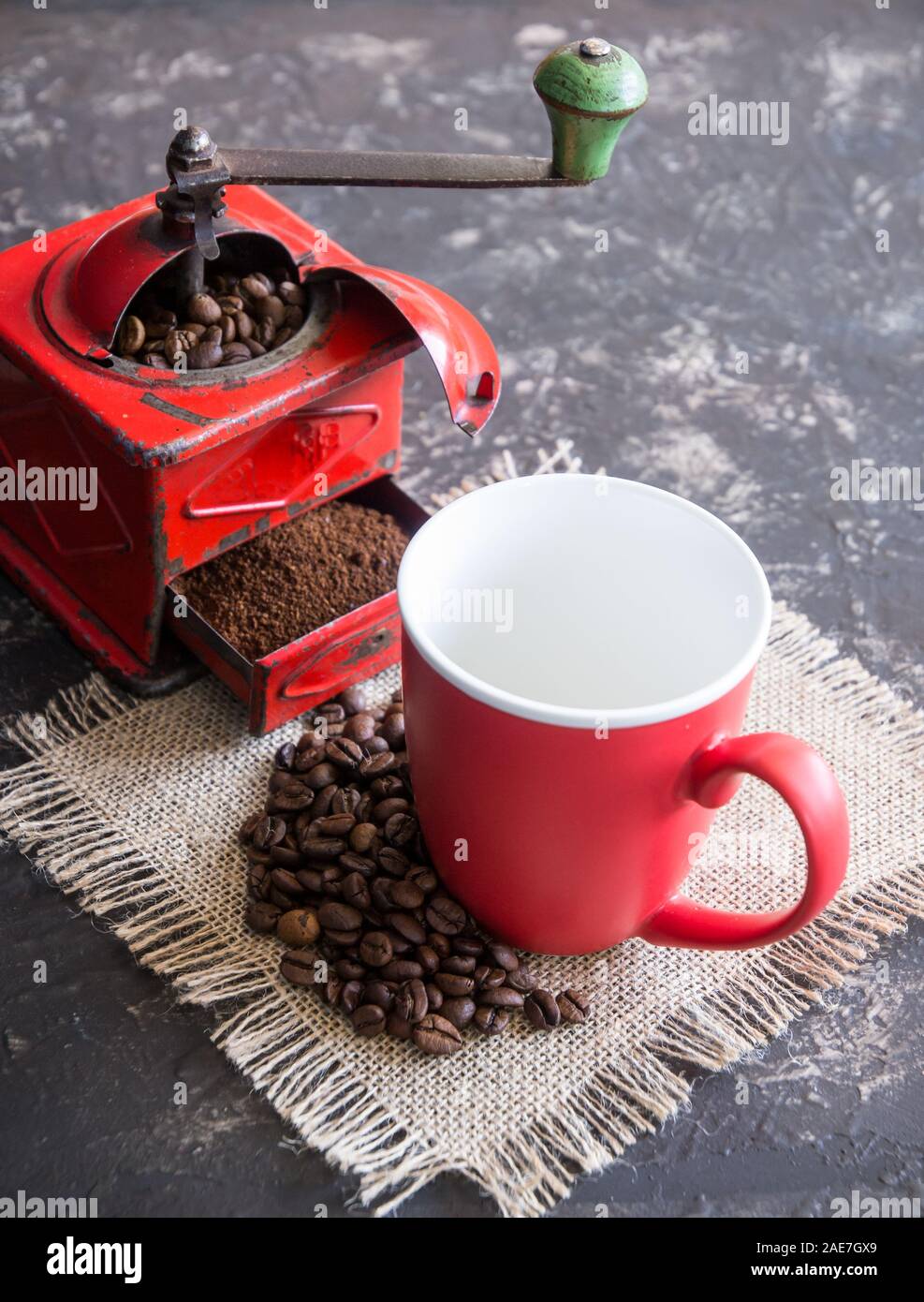 Vintage red coffee grinder, red cup, with coffee beans Stock Photo Alamy