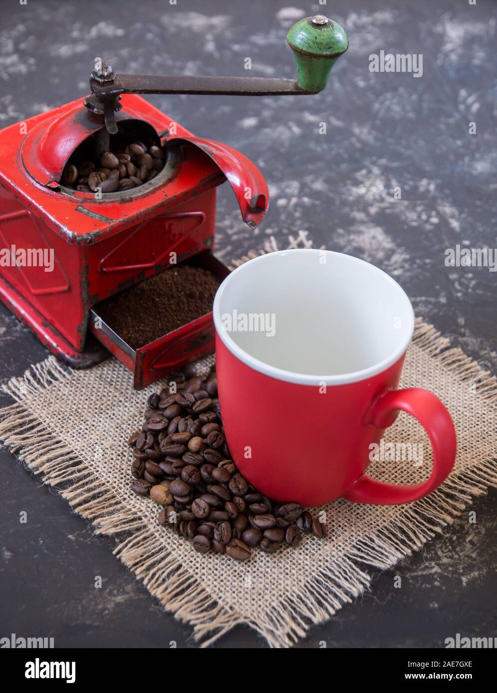 Vintage red coffee grinder, red cup, with coffee beans Stock Photo Alamy