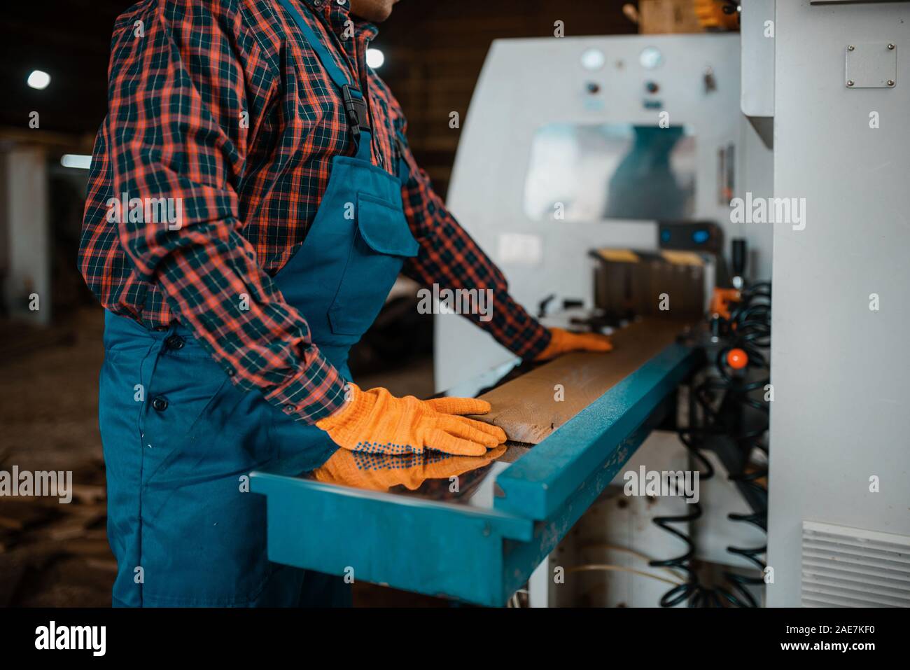 Woodworker works on machine, lumber industry Stock Photo - Alamy
