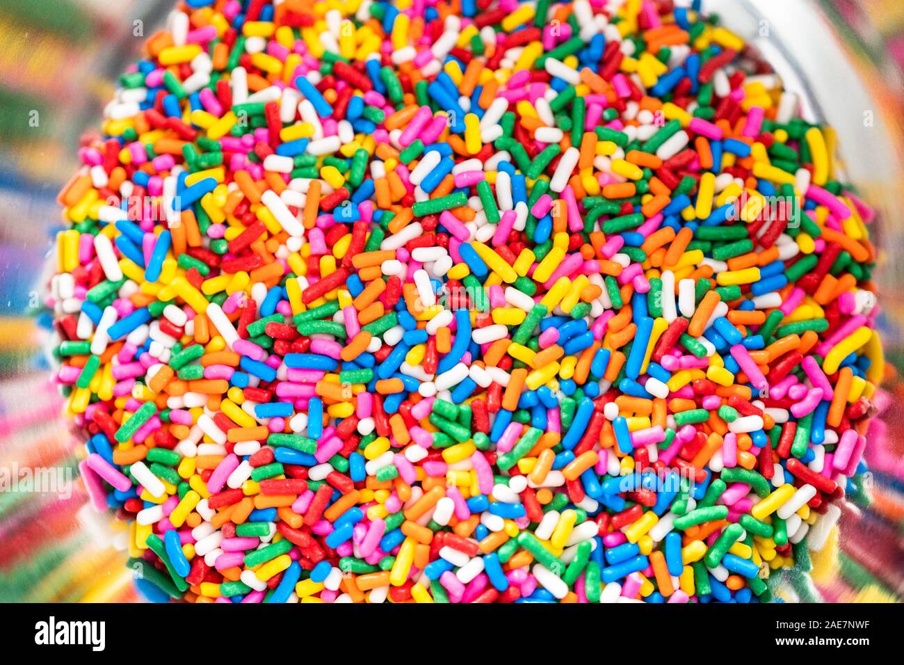 Mixing ingredients to bake birthday funfetti cake with colorful