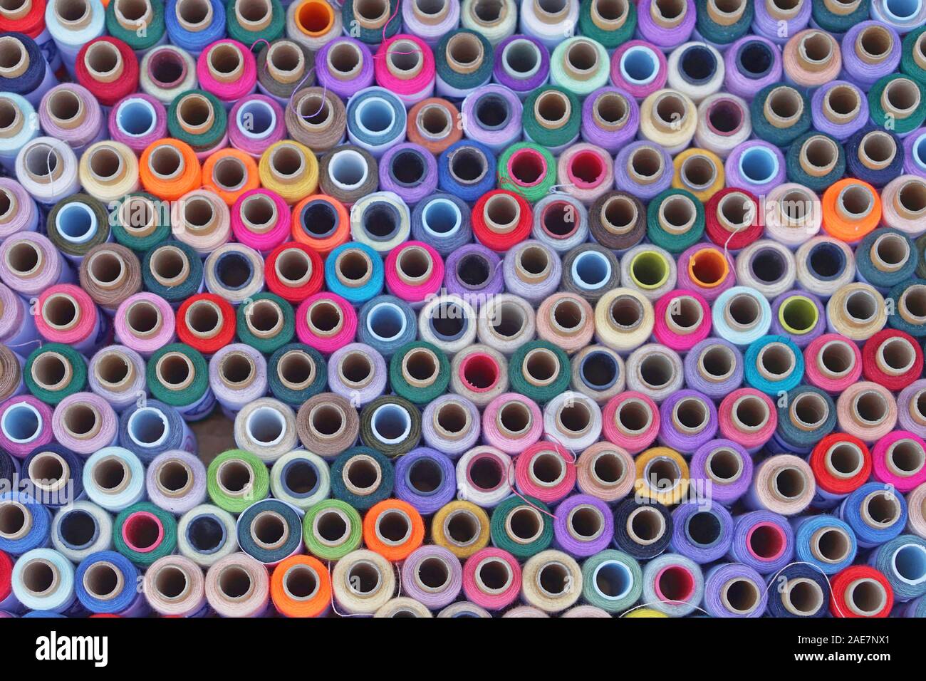 Colorful sewing yarns and threads background Stock Photo Alamy