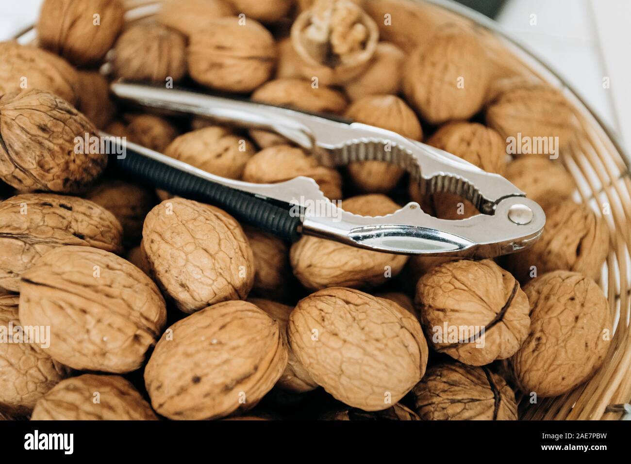 Nutcracker and walnuts in a large bowl Stock Photo