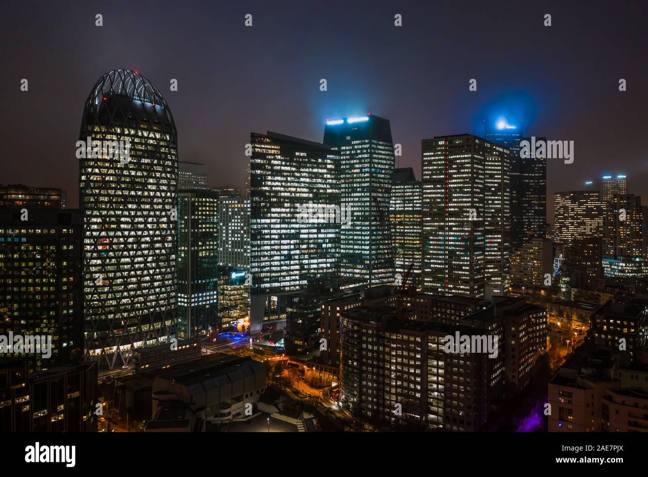 Aerial drone night shot of Skyscrapers with lights on in La Defense, financial district of Paris Stock Photo