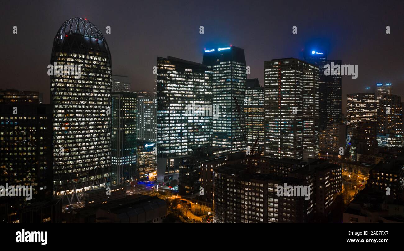 Paris, France - December 5, 2019: Aerial drone night shot of Skyscrapers with lights on in La Defense district Stock Photo