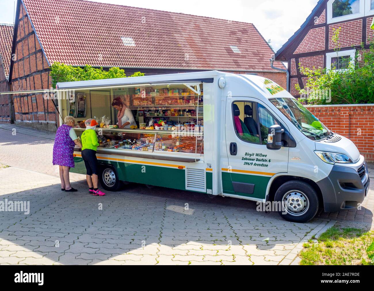 Two women buying food from mobile food van in village of Beuster  Saxony-Anhalt Germany Stock Photo - Alamy