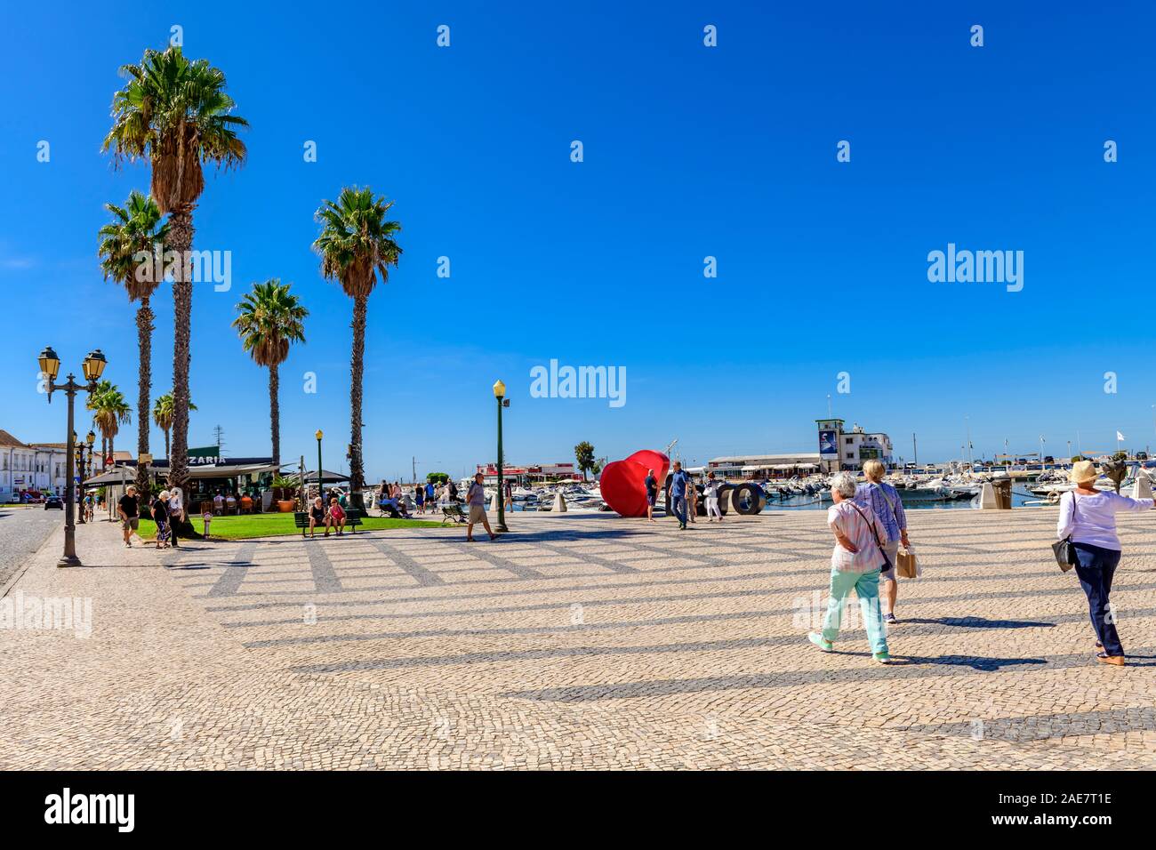 View across the square paved with traditional Portuguese cobbles calcada looking towards Faro marina. Faro Algarve Portugal. Stock Photo