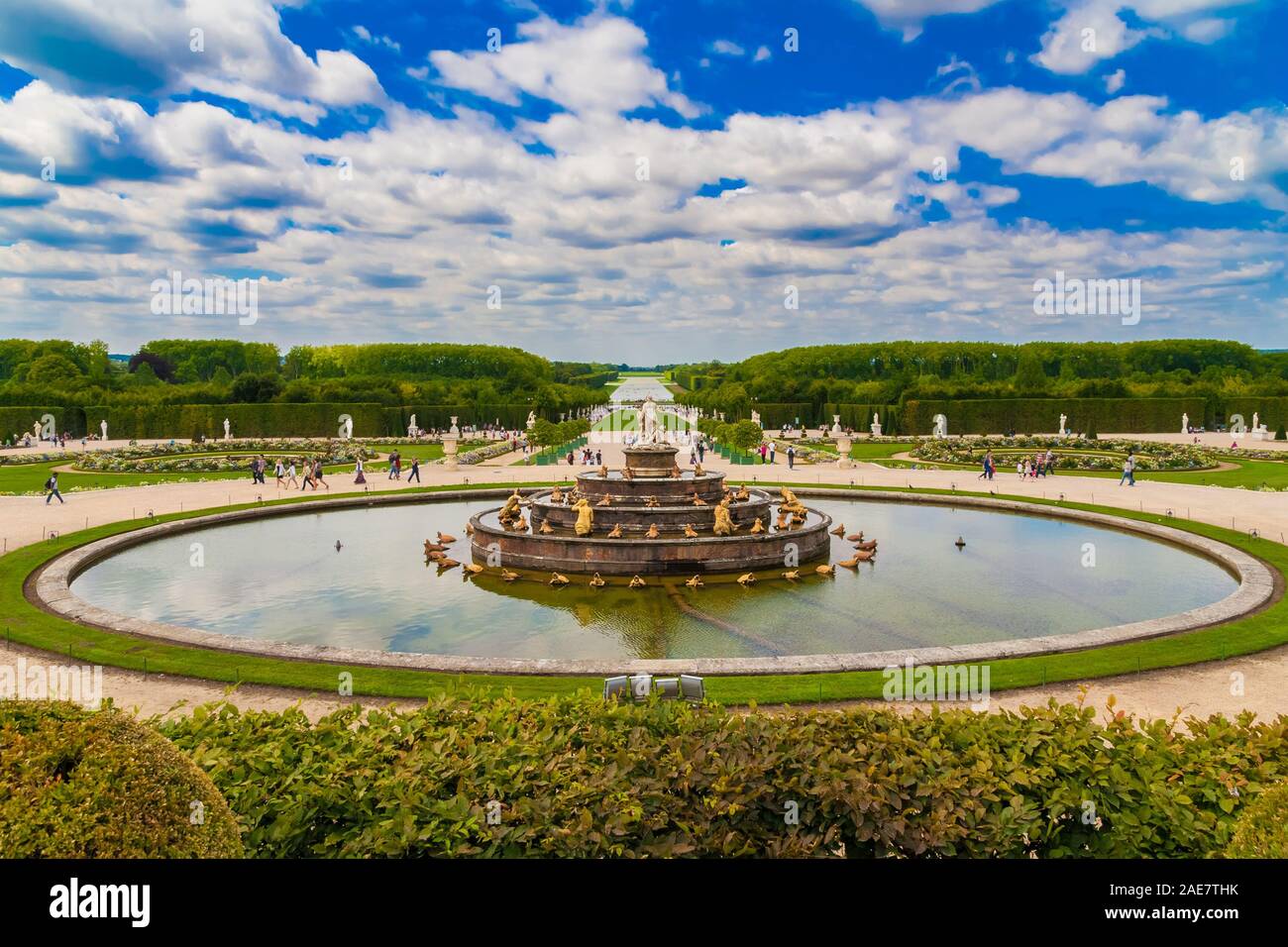 Great panoramic landscape view of the Latona Fountain (Bassin de Latone) in the Gardens of Versailles with the Grand Canal in the background on a nice... Stock Photo
