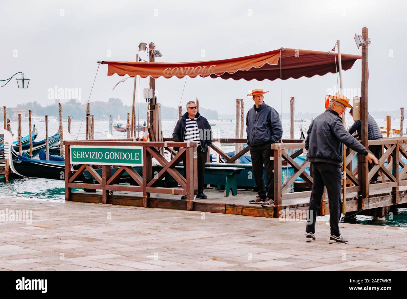 Gondoliers, waiting, gondola station, St. Mark's Square Venice Italy, tourist concept, boat ride, boats, canal ride, gondalos, gondola's, attraction Stock Photo