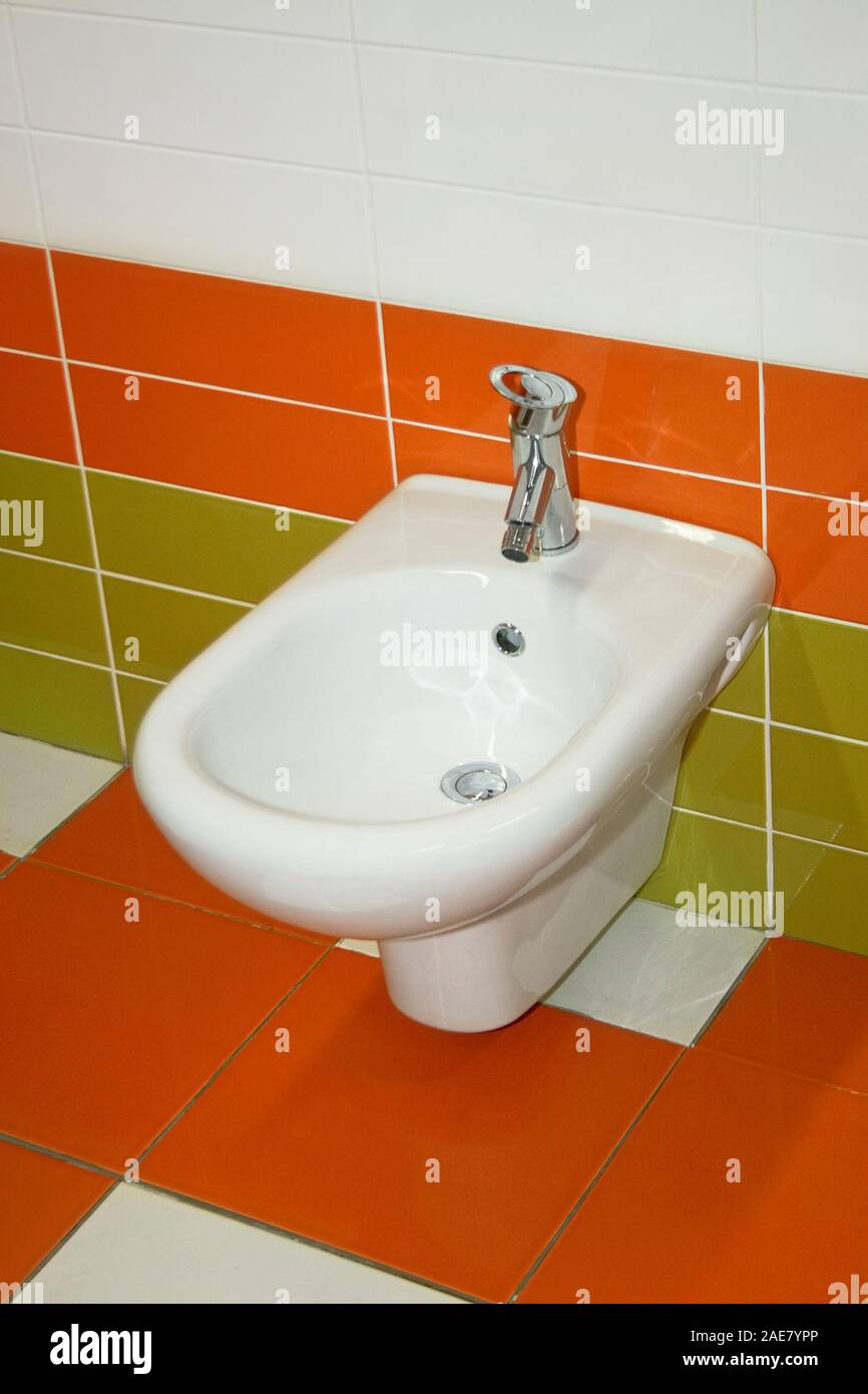 Modern bathroom with orange and green ceramics Stock Photo - Alamy