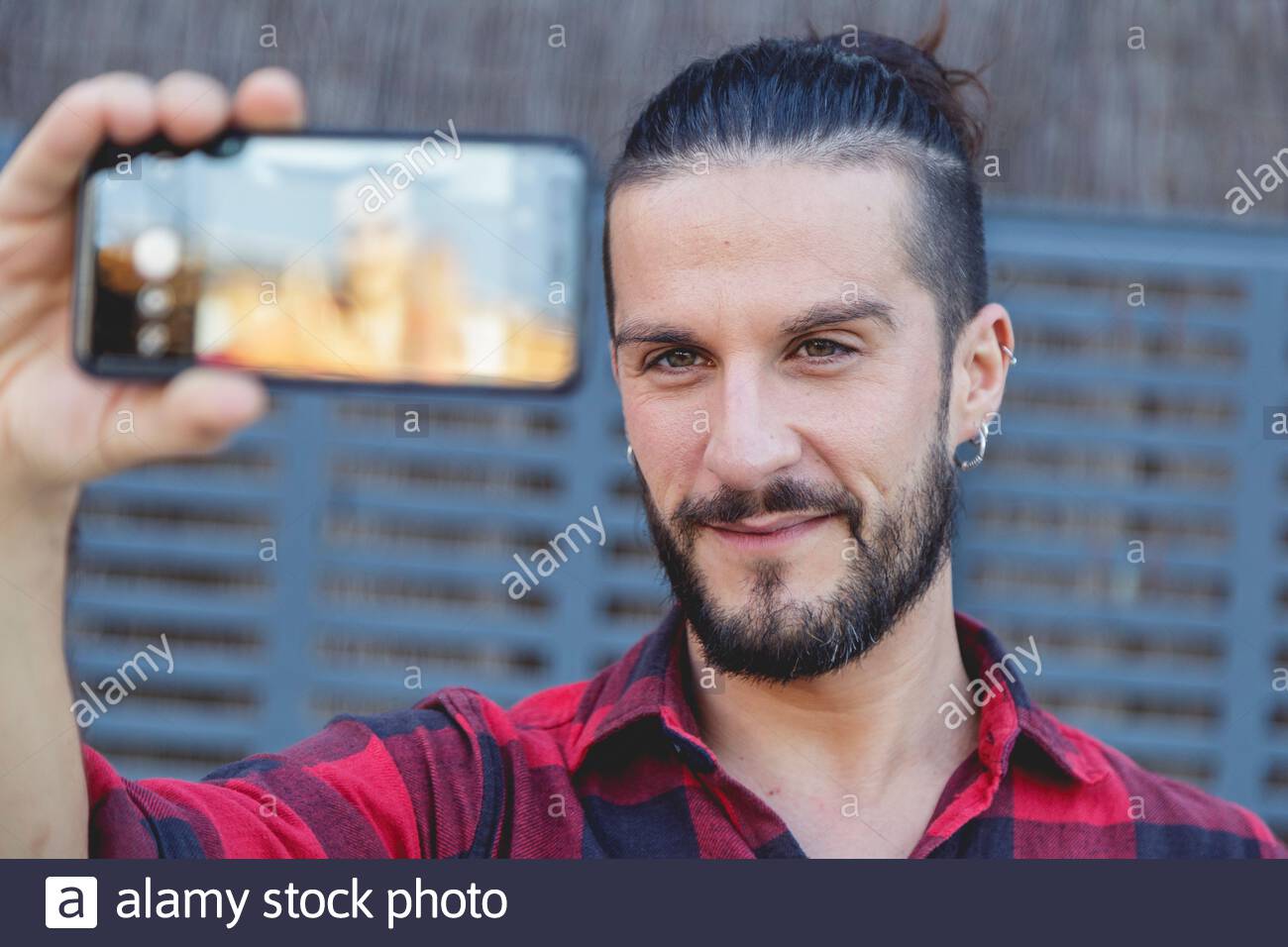 Long Haired Young Man Takes A Selfie A Bearded Young Man Smiling