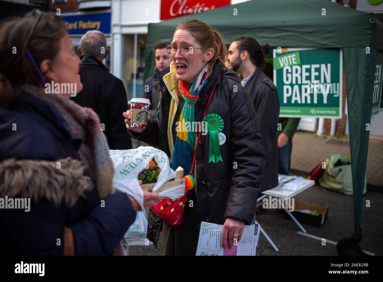 Essex, UK. 7th December 2019. Saffron Walden Essex UK 7 Dec 2019 Coby Wing Green Party candidate standing in 2019 General Election Coby Wing standing as the Green Party candidate in the 2019 British General Election to be held on 12 December 2019 with helpers on the Green Party stall in Saffron Walden in the constituency in north West Essex.The former ‘middle class’ homeless child and graduate on Job-Seekers allowance who has trained as a midwife and worked recently as a civil servant in education says she is targetting the local Tory Party vote in Kemi Badenoch rather than standing aside to h Stock Photo