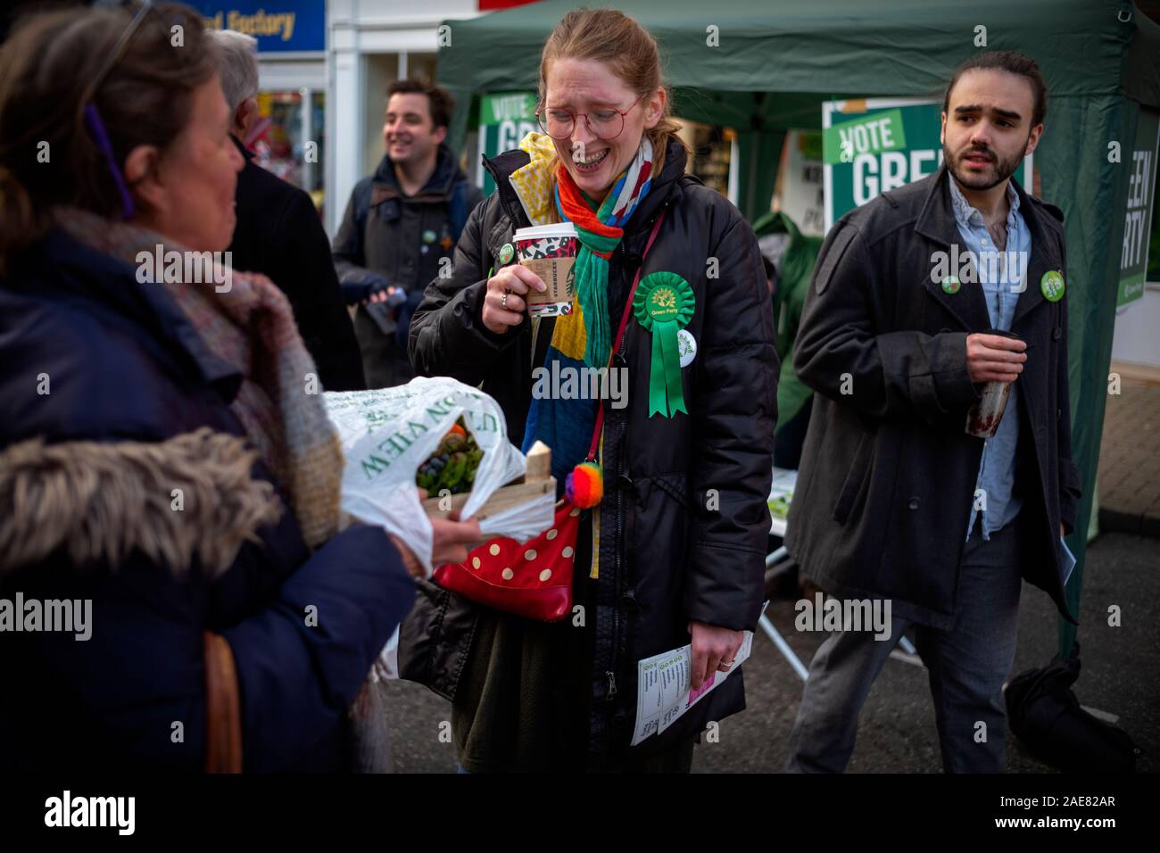 Essex, UK. 7th December 2019. Saffron Walden Essex UK 7 Dec 2019 Coby Wing Green Party candidate standing in 2019 General Election Coby Wing standing as the Green Party candidate in the 2019 British General Election to be held on 12 December 2019 with helpers on the Green Party stall in Saffron Walden in the constituency in north West Essex.The former ‘middle class’ homeless child and graduate on Job-Seekers allowance who has trained as a midwife and worked recently as a civil servant in education says she is targetting the local Tory Party vote in Kemi Badenoch rather than standing aside to h Stock Photo