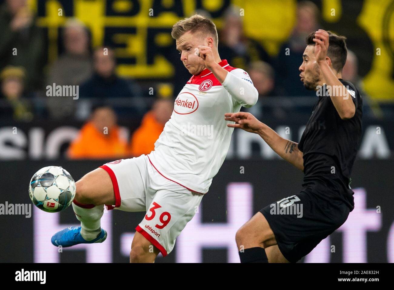 Dortmund, Germany. 07th Dec, 2019. Soccer: Bundesliga, Borussia Dortmund - Fortuna Düsseldorf, 14th matchday, at Signal-Iduna-Park. Düsseldorf's Jean Zimmer (l.) and Dortmund's Raphael Guerreiro fight for the ball. Credit: David Inderlied/dpa - IMPORTANT NOTE: In accordance with the requirements of the DFL Deutsche Fußball Liga or the DFB Deutscher Fußball-Bund, it is prohibited to use or have used photographs taken in the stadium and/or the match in the form of sequence images and/or video-like photo sequences./dpa/Alamy Live News Stock Photo