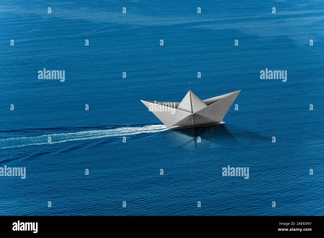 White paper boat runs fast over the blue sea with wake, photography aerial view Stock Photo