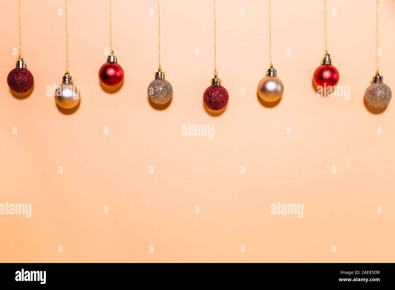 Christmas balls hanging on a beige background. Chistmas concept. Stock Photo