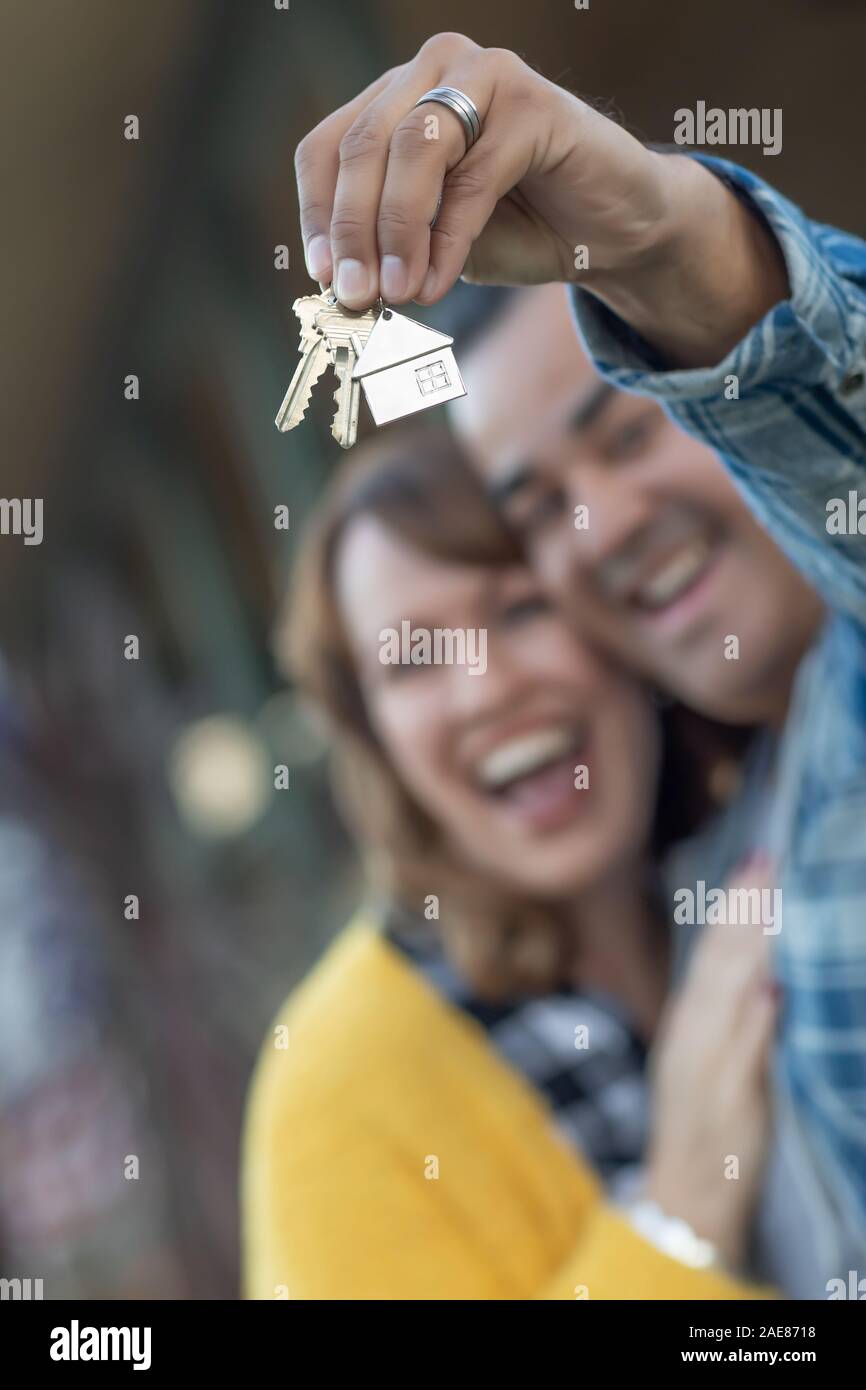 Mixed Race Couple Holding New House Keys Stock Photo - Alamy