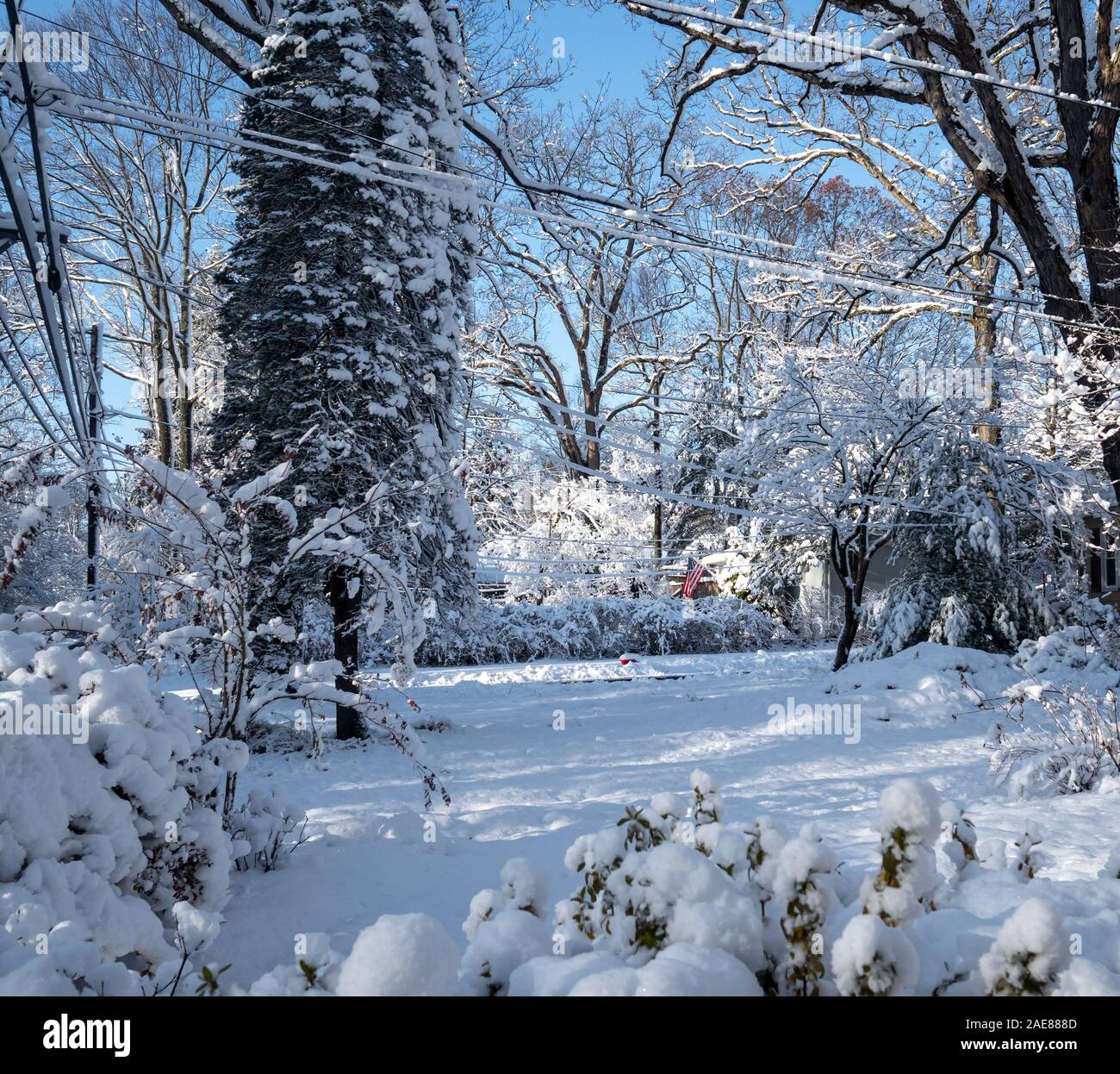 suburban house after the first snow storm of the season in the American ...