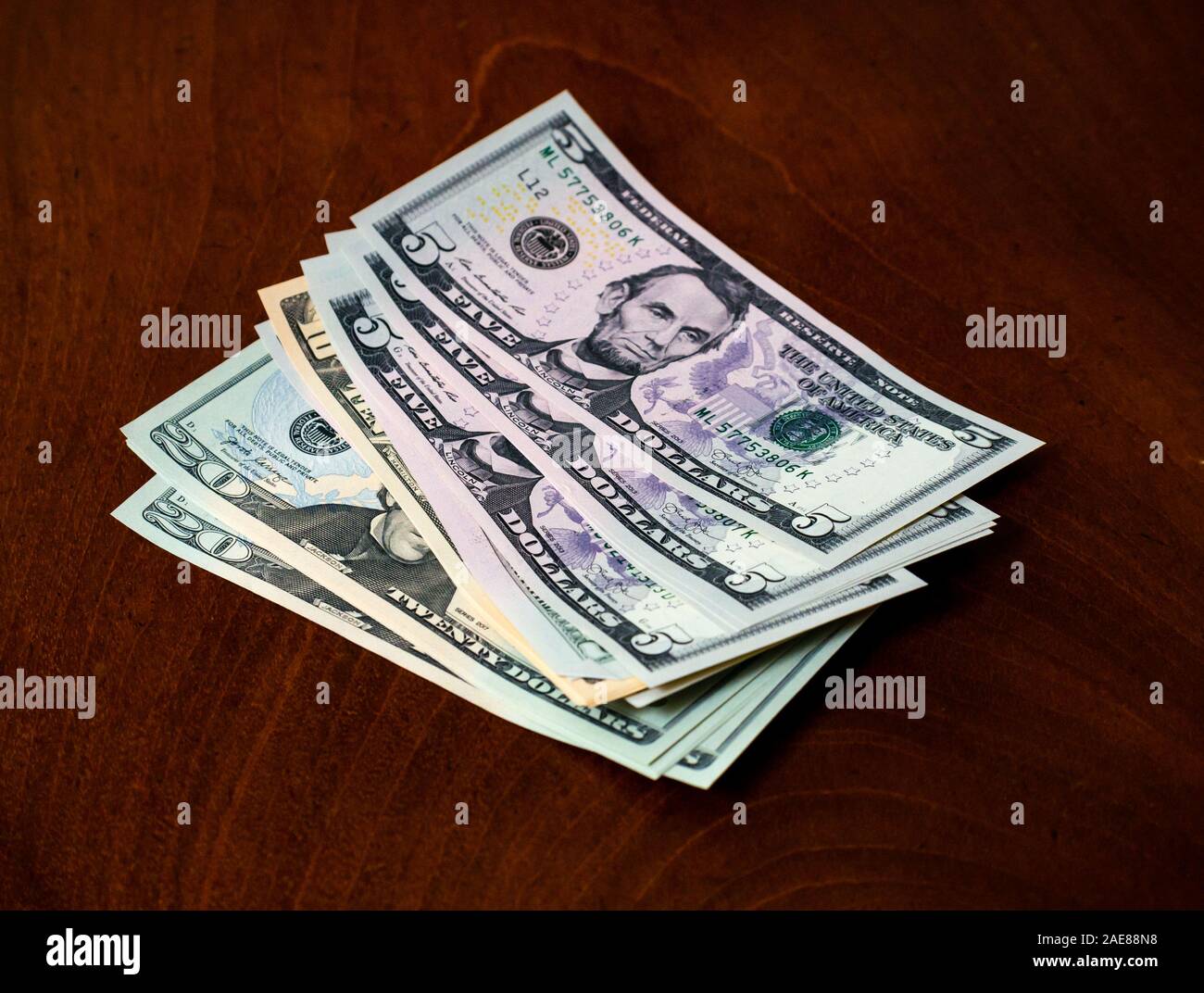 Pile of American (US) money with five, ten & twenty dollar bills featuring US president Abraham Lincoln Stock Photo