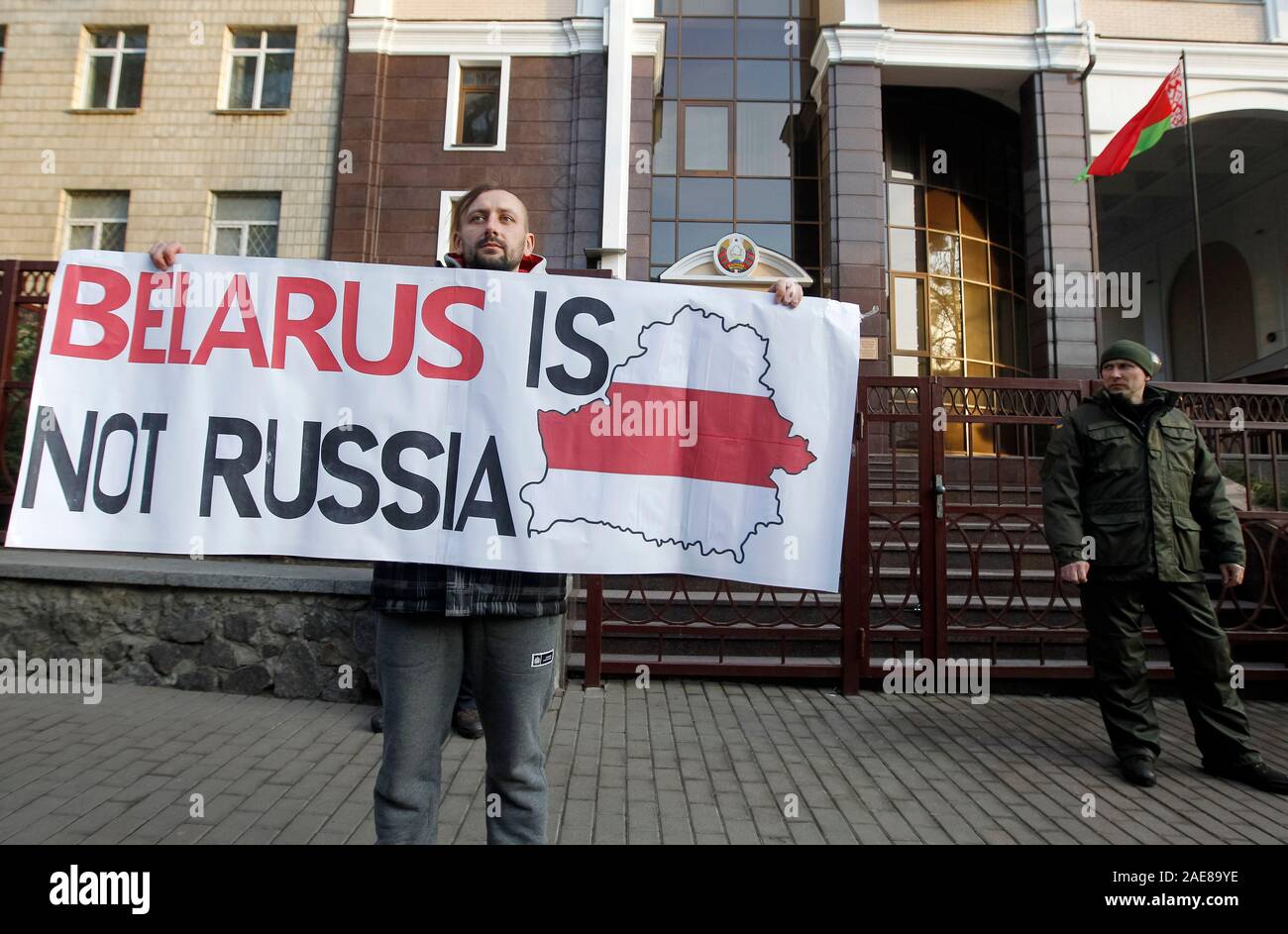 An activist holds a placard during a protest against the Belarus-Russia integration program, outside the Belarusian Embassy in Kiev.Protesters oppose the integration of Belarus and Russia and consider that sign a new agreement of deepening integration can lead to Belarus losing its independence. Presidents of Russia and Belarus, Vladimir Putin and Alexander Lukashenko meet and talk about road maps for the integration of the two countries taking place in Russia on December 7, 2019, reportedly by media. Stock Photo
