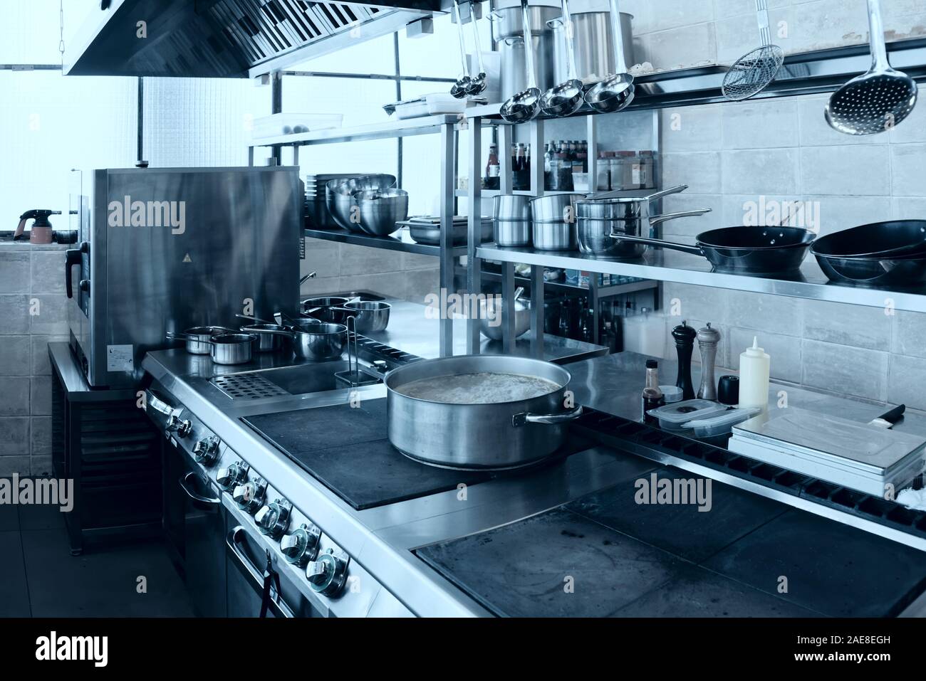 large and small pots in the industrial kitchen on the stove inside the  restaurant during the preparation of food Stock Photo - Alamy