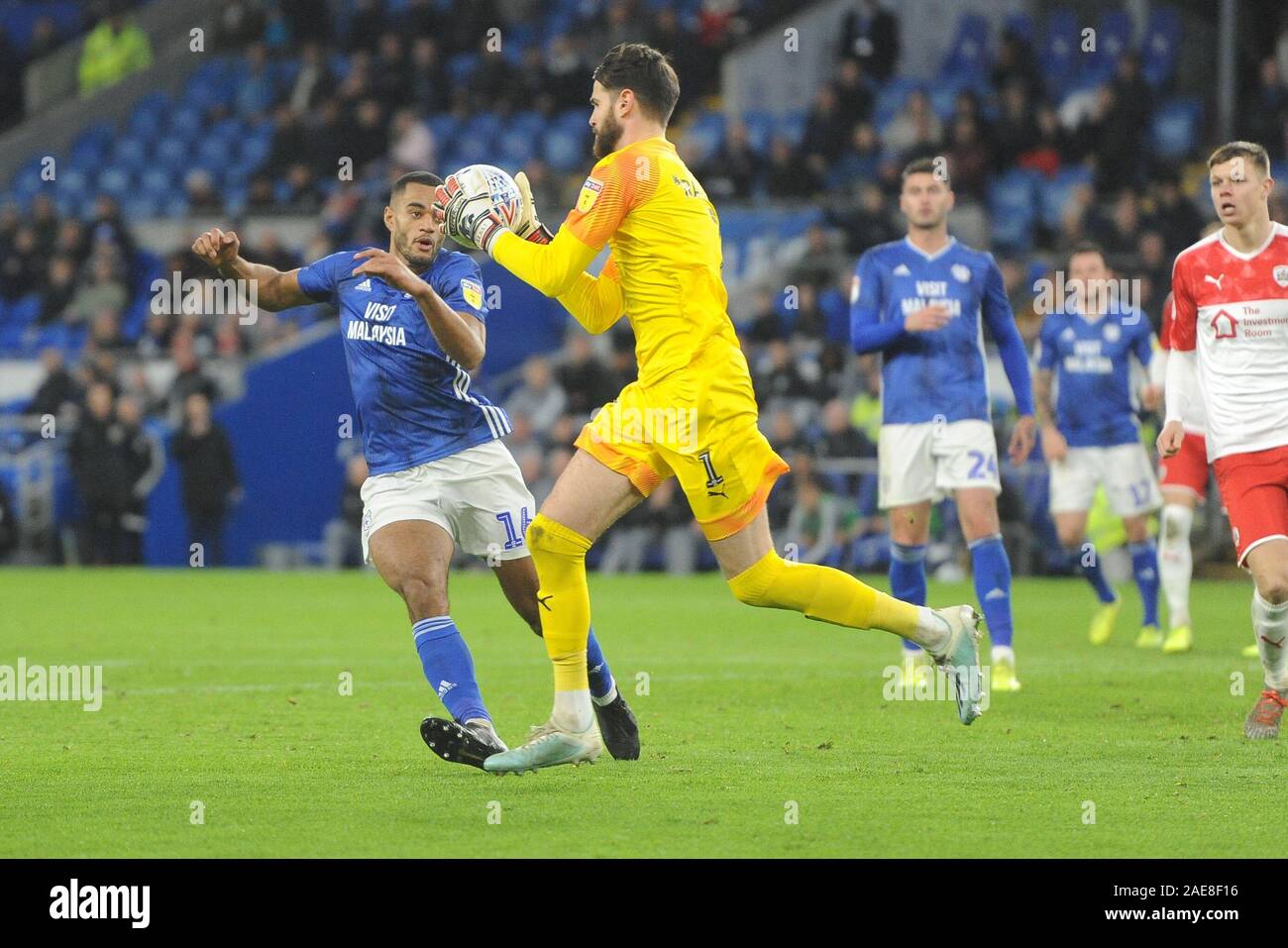 CARDIFF, WALES - NOVEMBER 7TH Curtis Nelson of Cardiff City challenges Barnsley goalkeeper Samuel Sahin-Radlnger during the Sky Bet Championship match between Cardiff City and Barnsley at the Cardiff City Stadium, Cardiff on Saturday 7th December 2019. (Credit: Jeff Thomas | MI News)Photograph may only be used for newspaper and/or magazine editorial purposes, license required for commercial use Credit: MI News & Sport /Alamy Live News Stock Photo