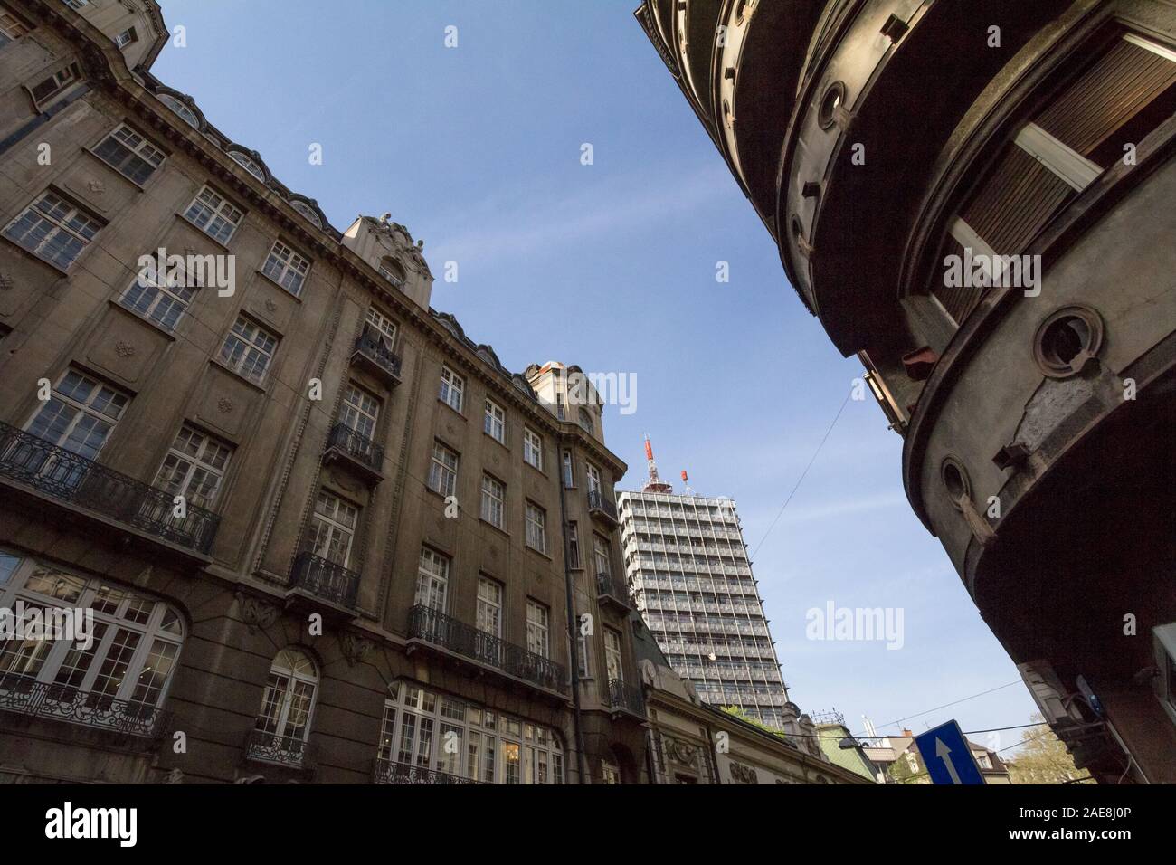 Old residential buildings made of concrete and a 70s high rise steel skyscraper in the city center of Belgrade, the capital city of Serbia, during a s Stock Photo