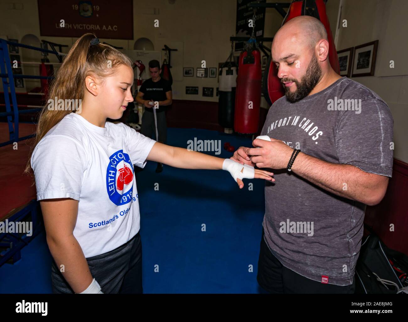 Frances Heath getting hands wrapped by coach Gary Young, Leith Victoria Boxing Club, Edinburgh, Scotland, UK Stock Photo